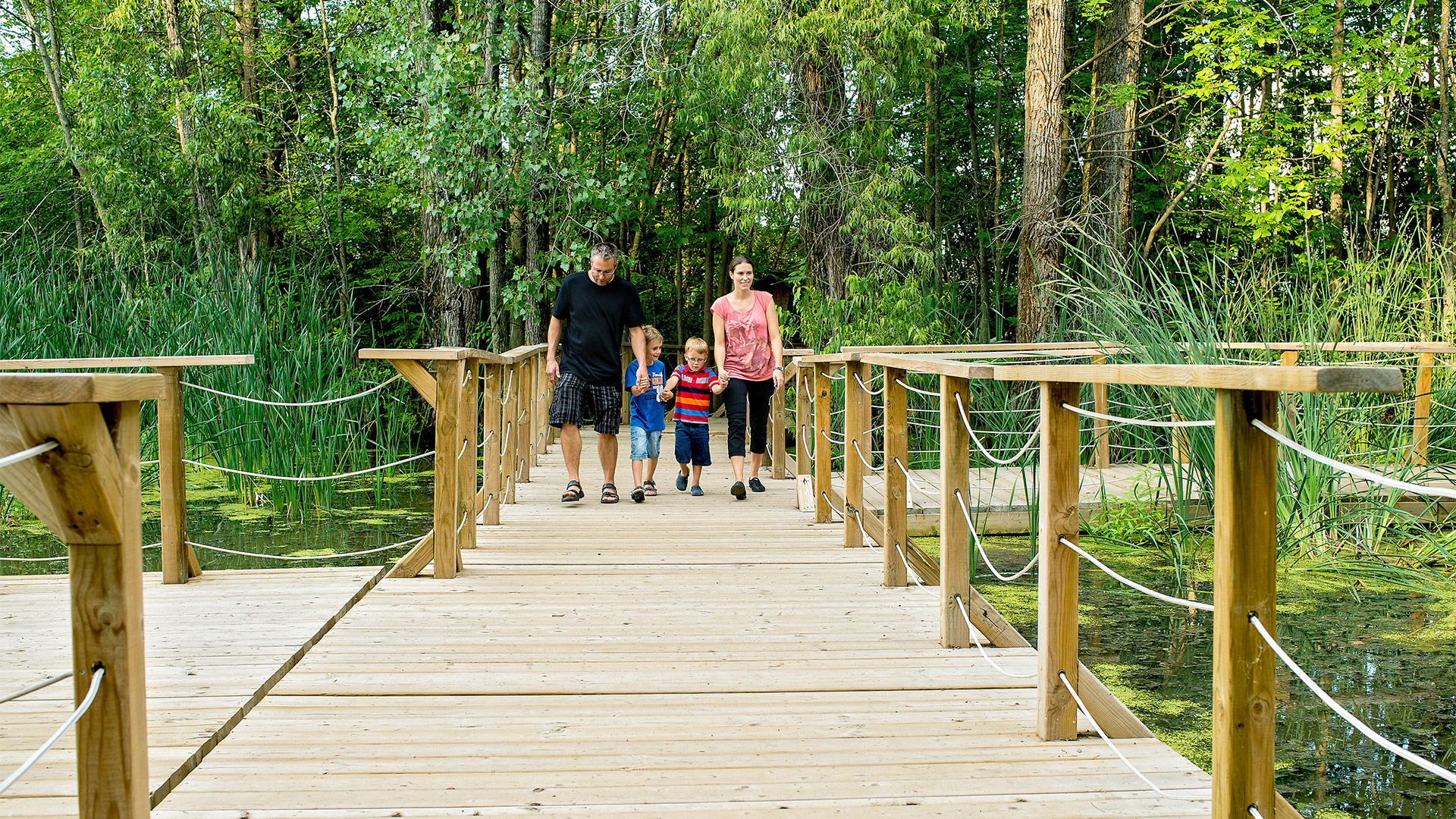 young family walking through the Ecomuseum Zoo